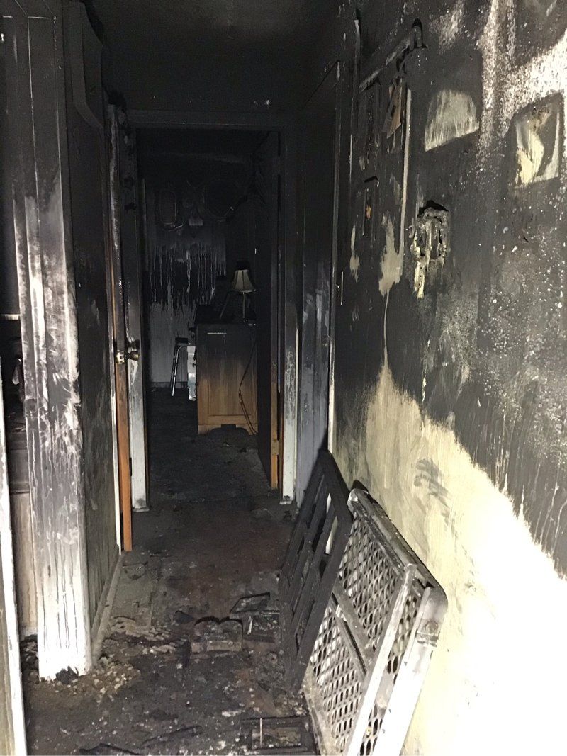 A hallway in a home that has been damaged by a fire.