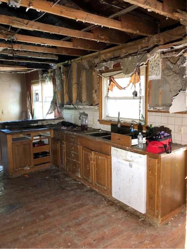 A kitchen in a house that is being repaired from fire damage.