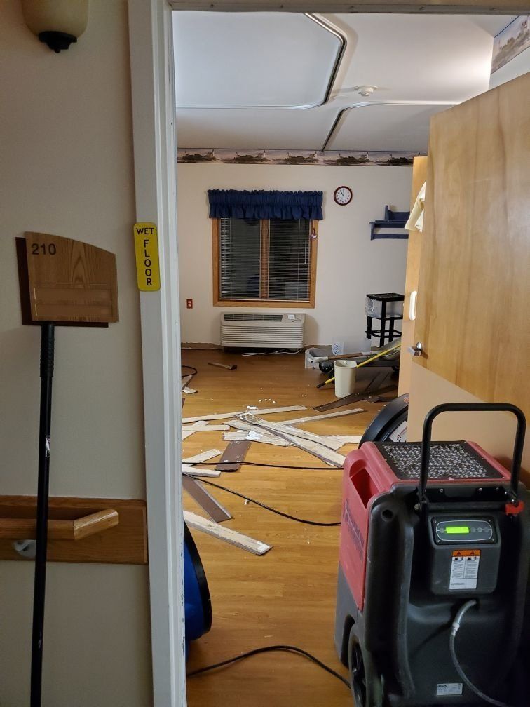 A water damaged room with an industrial drying machine.