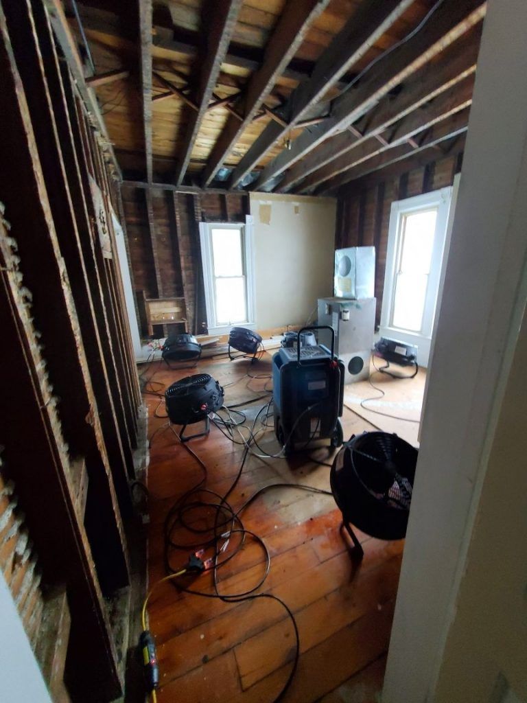 A room with a lot of wires hanging from the ceiling.