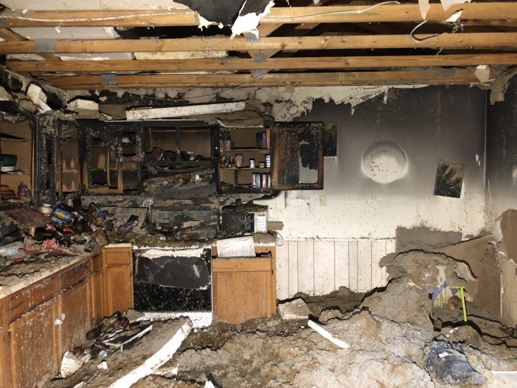 A kitchen in a house that has been damaged by a fire.