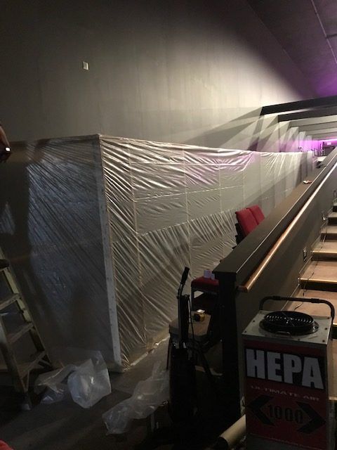 A room with a vacuum cleaner and a box that says hepa on it.