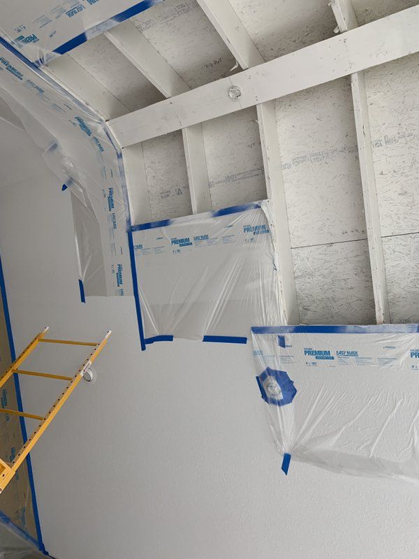 A ceiling is being repaired from chimney fire in a room with a ladder.