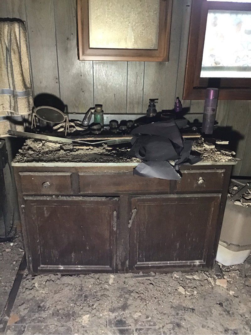 A room with fire damaged cabinets.