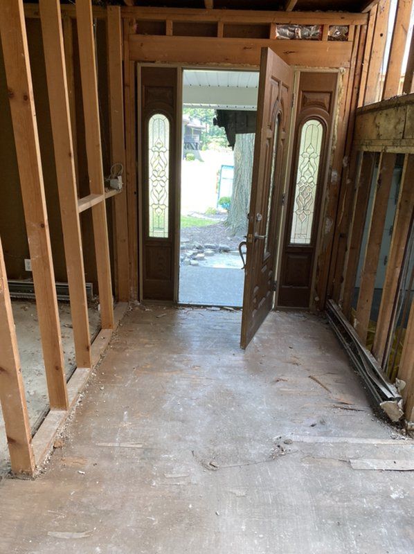 A door is open in a room with a wooden frame.