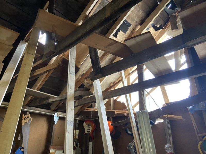 A room with a lot of wooden beams and a window.