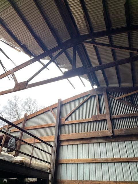 Looking up at the roof of a building with wooden beams