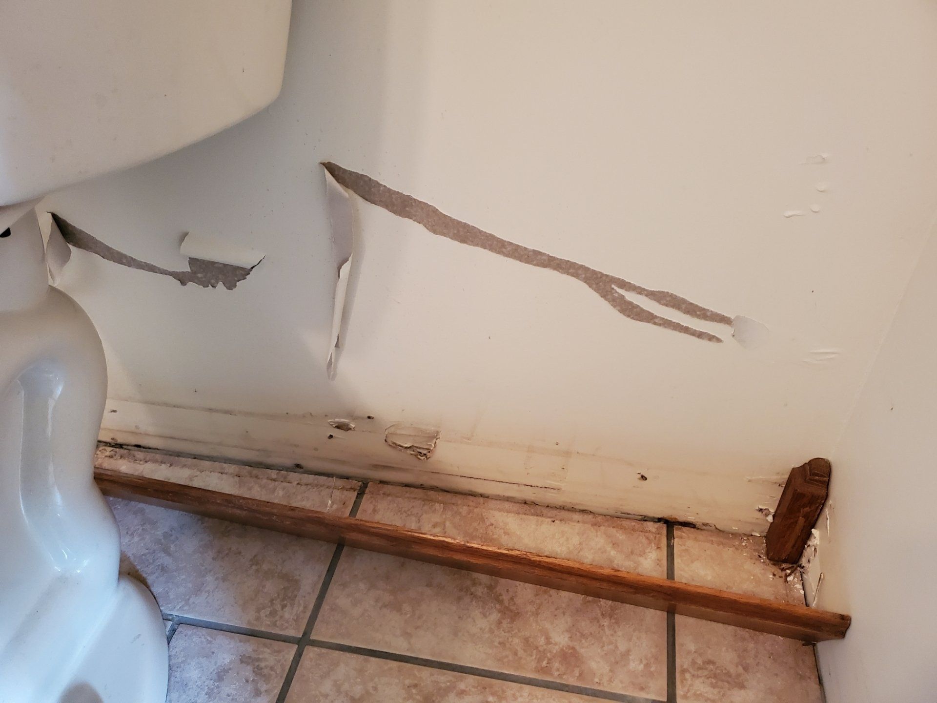 Water damaged bathroom with a toilet.