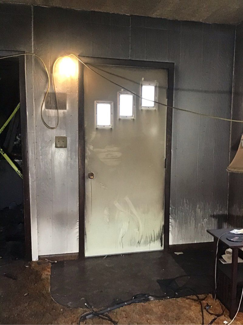 A room with a door and lamp.