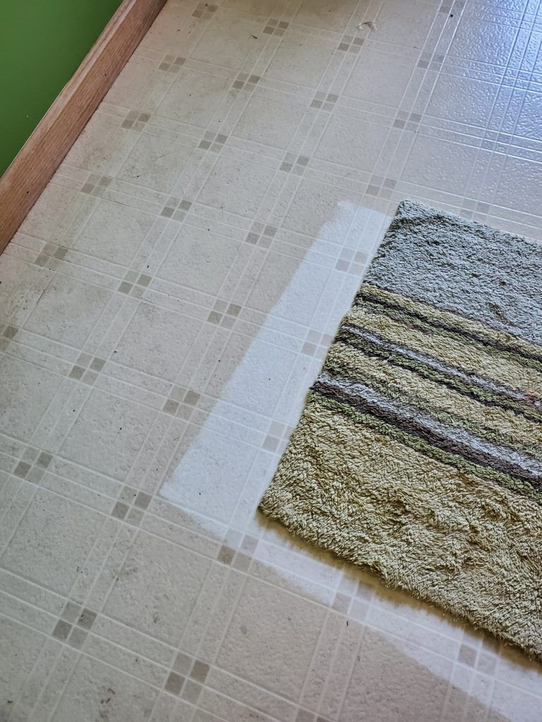 A rug is sitting on top of a tiled floor.
