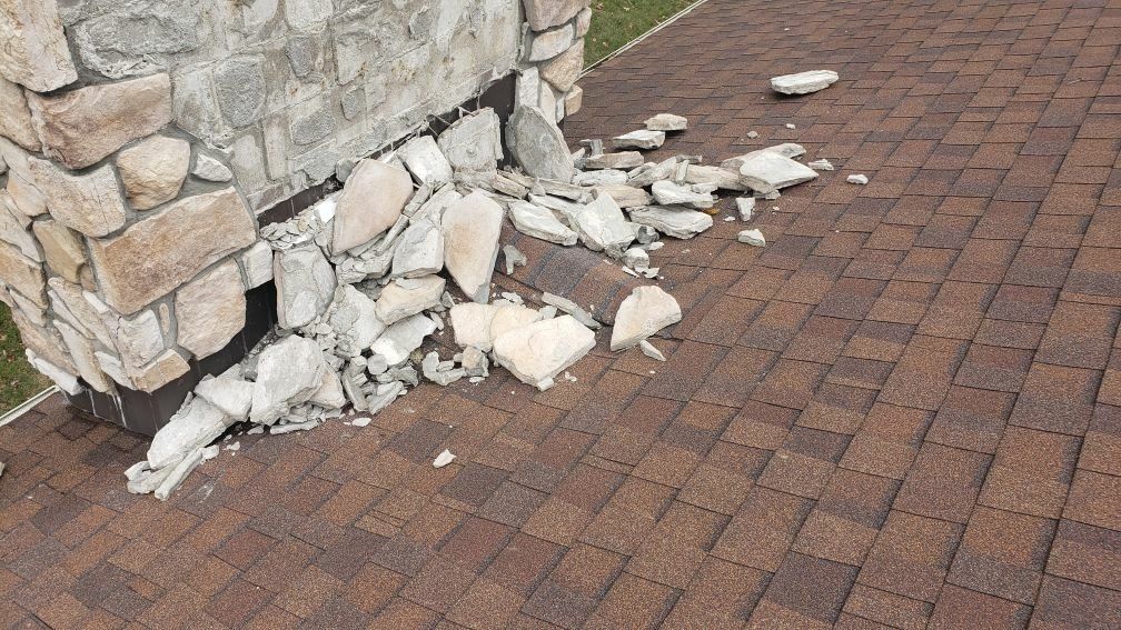 A stone chimney that has been damaged.
