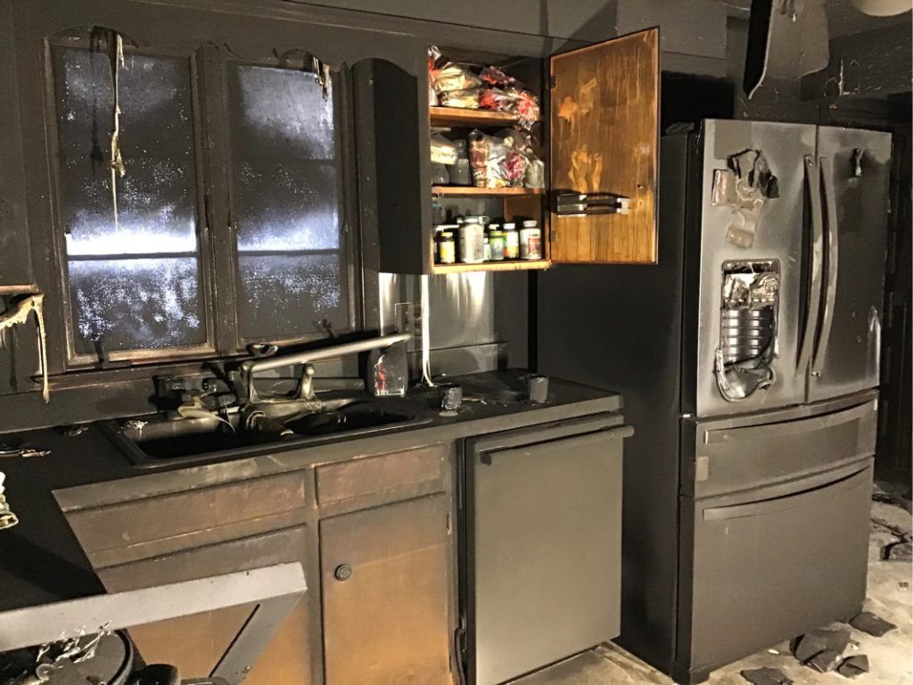 A kitchen with a stainless steel refrigerator and dishwasher