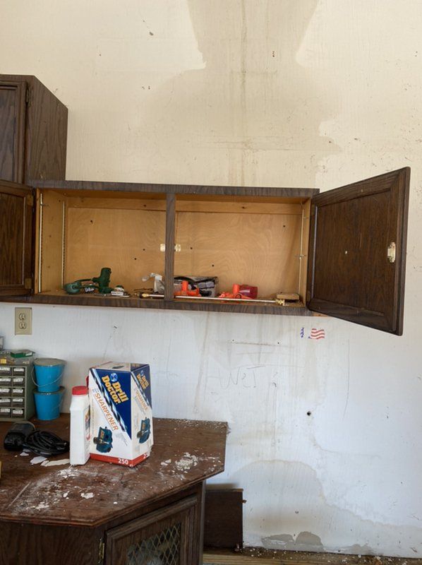 An empty cabinet with the door open in a room.