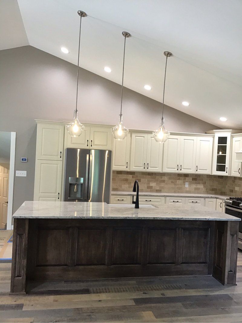 A kitchen with white cabinets and stainless steel appliances.