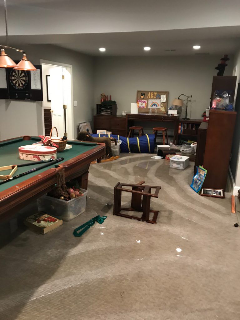 There is a pool table in the middle of the room.