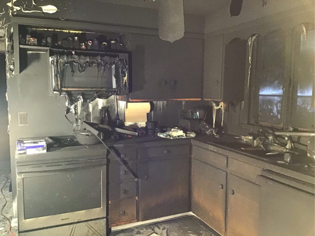 A kitchen that has been damaged by a fire