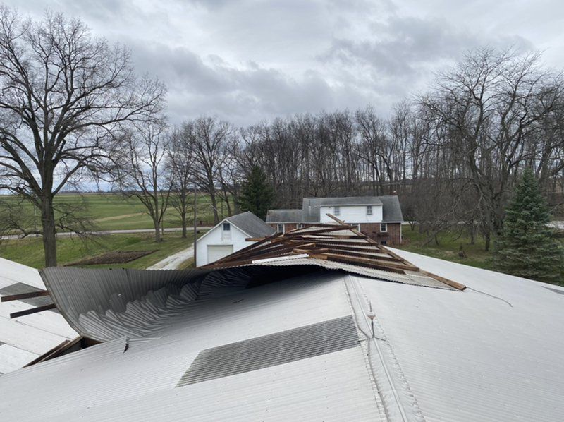 The roof of a house has been damaged by a storm.