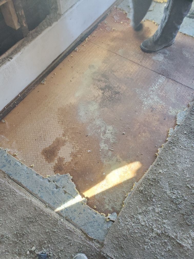 A boot is on a floor being remodeled.