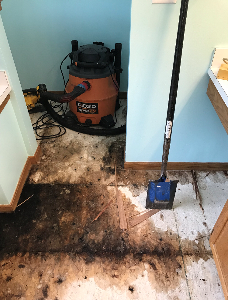 A row with water damaged floor and industrial vacuums.