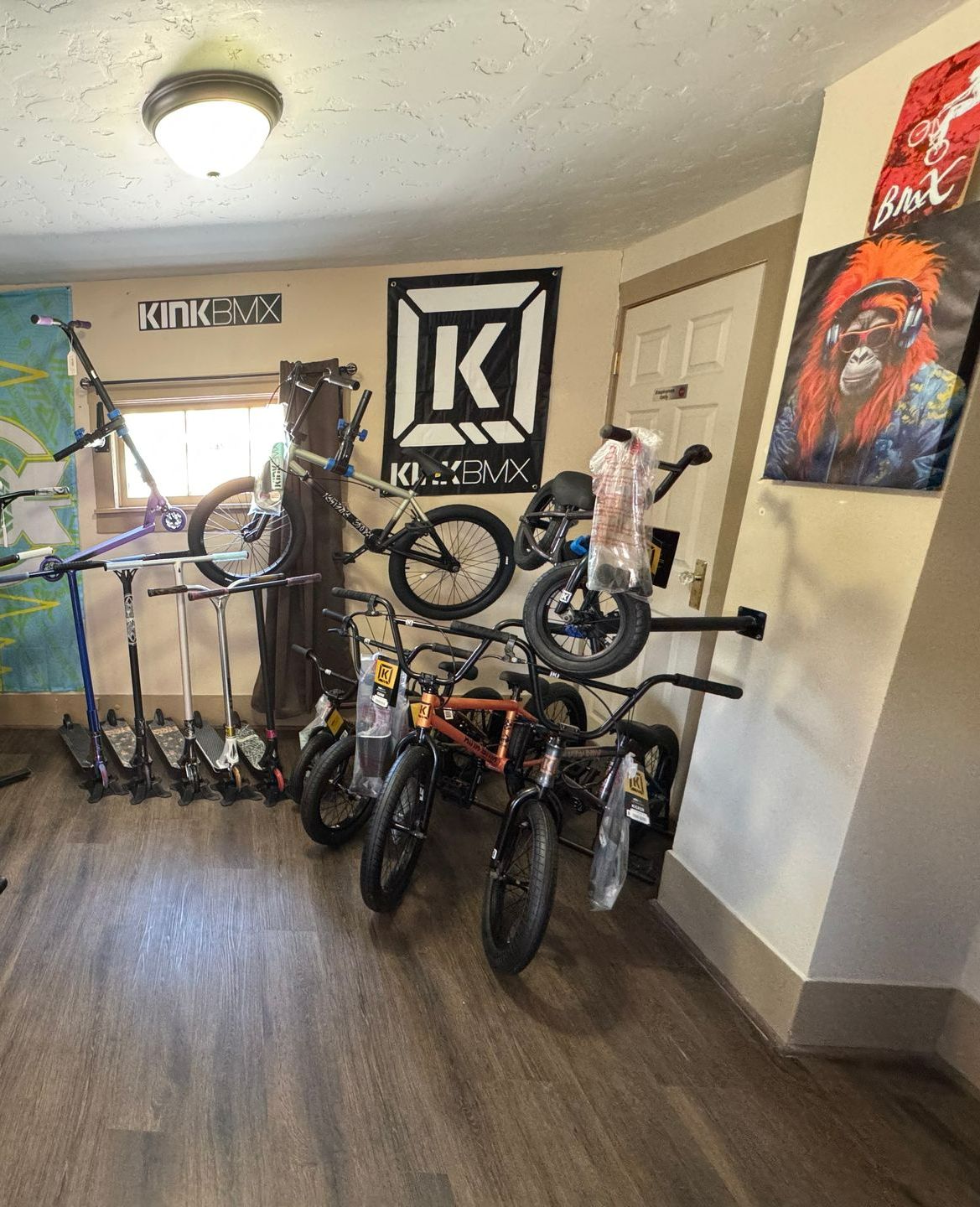 A room with a lot of bikes and scooters in it