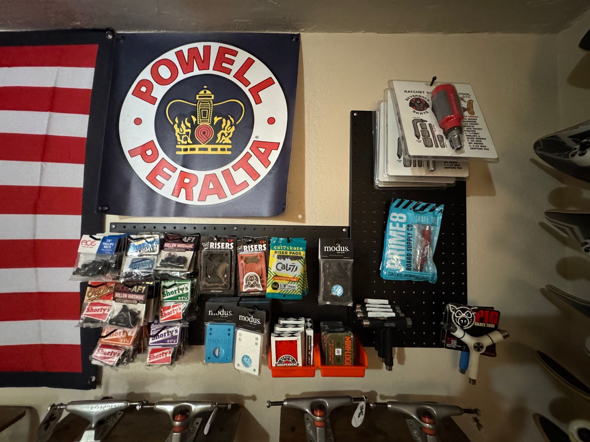 A powell peralta sign hangs above a display of skateboards