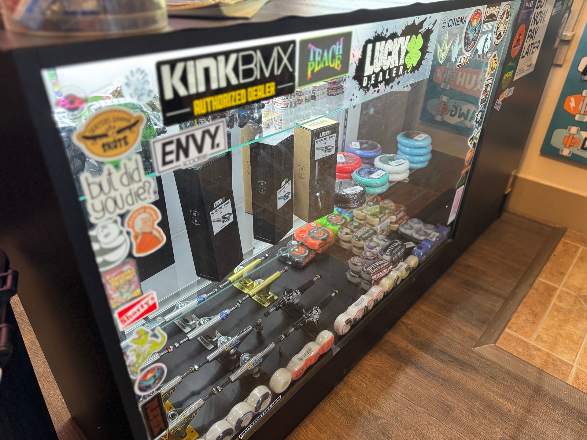 A display case with stickers on it that says kinkbmx