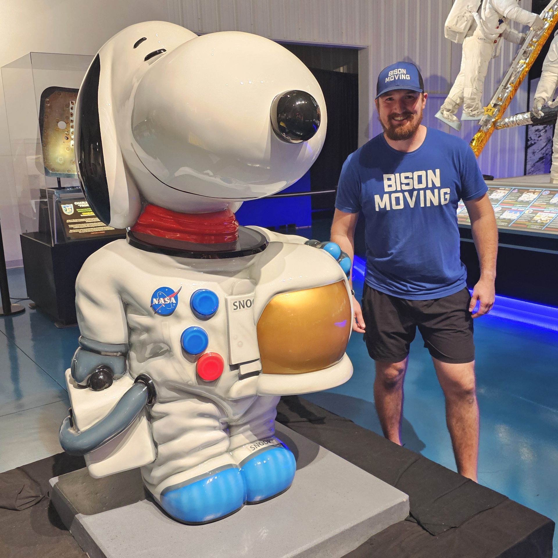 Two men are carrying a large white mattress out of a truck - Tulsa, OK - Bison Moving