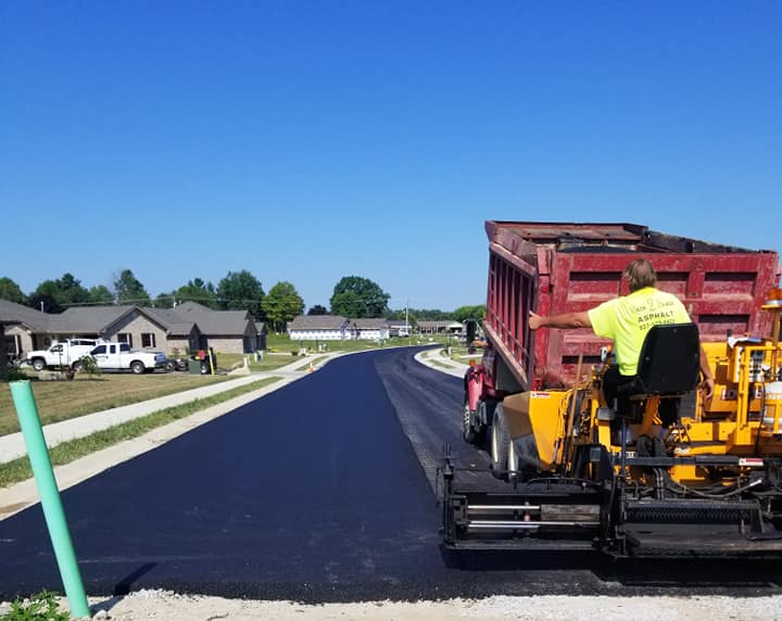Worker Regulate Tracked Paver Laying Asphalt — West Manchester, OH — Back 2 Black Asphalt