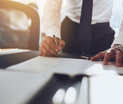 Executive signing letter placed on table
