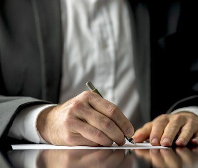 businessman writing on a paper