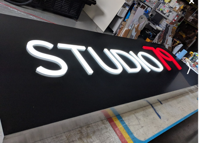 A black sign that says studio on it
