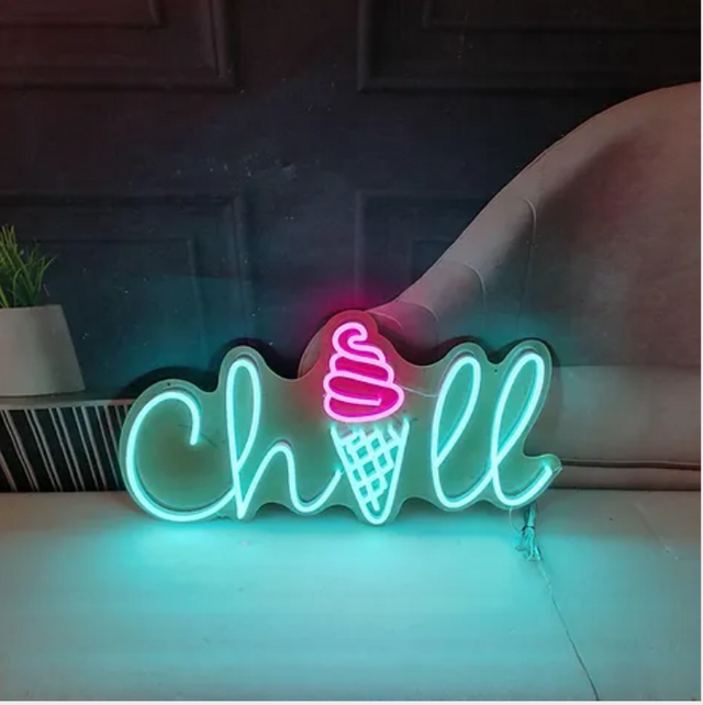 A neon sign that says chill with an ice cream cone