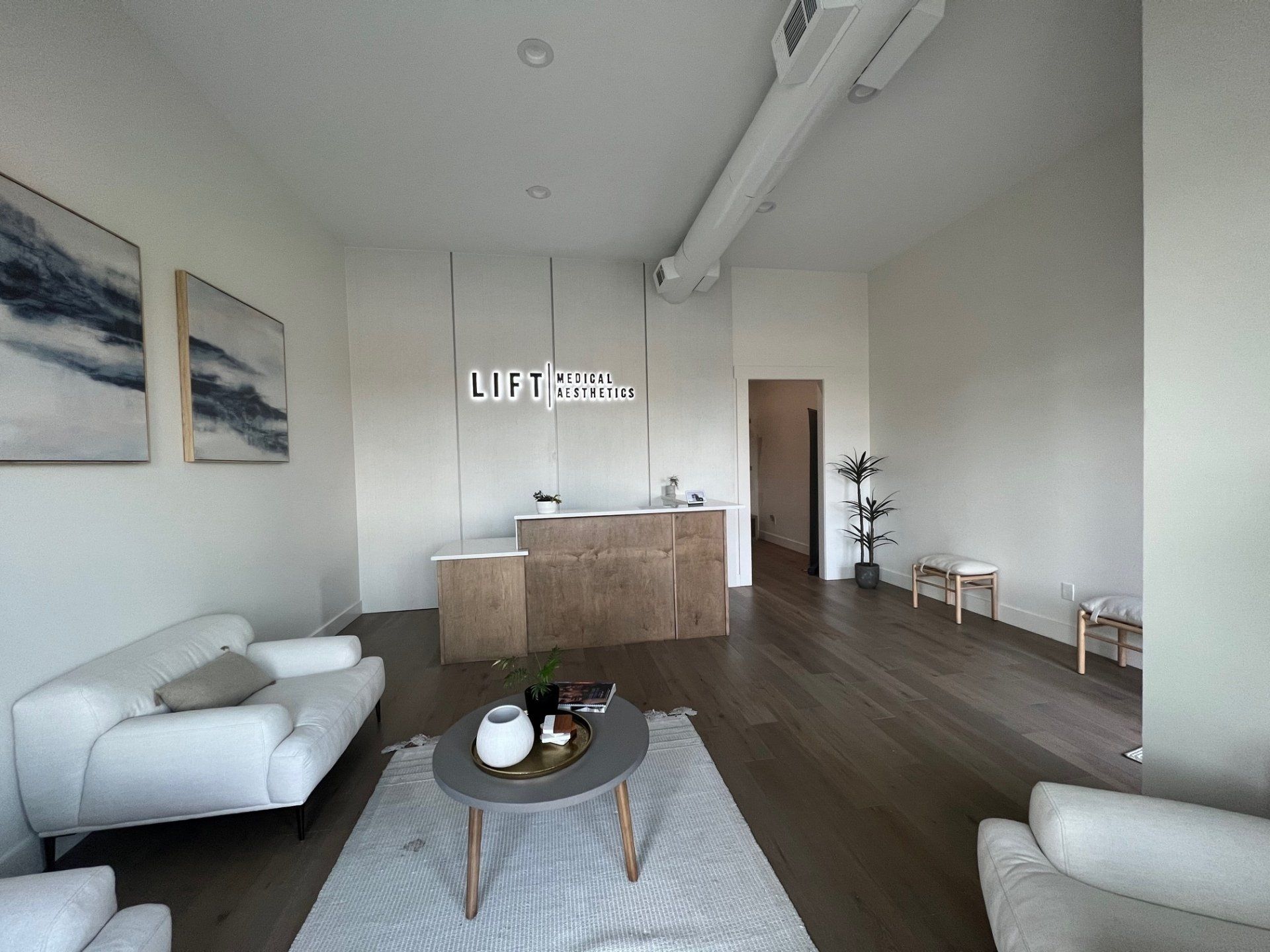 A living room with a couch , chairs , and a coffee table.