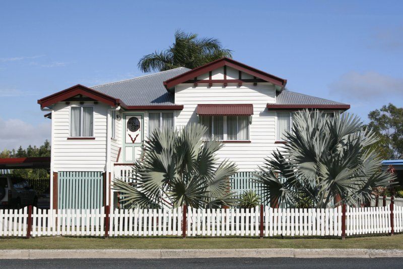 Traditional House with White Picket Fence — Building Compliance in Mackay, QLD