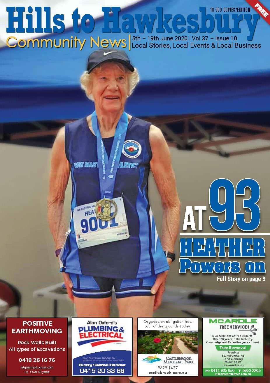 Woman, 93, in running gear, wearing a medal, on the cover of a community newspaper.
