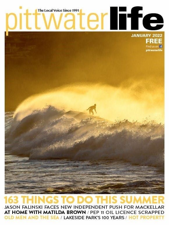 Magazine cover with surfer riding a wave at sunset, 