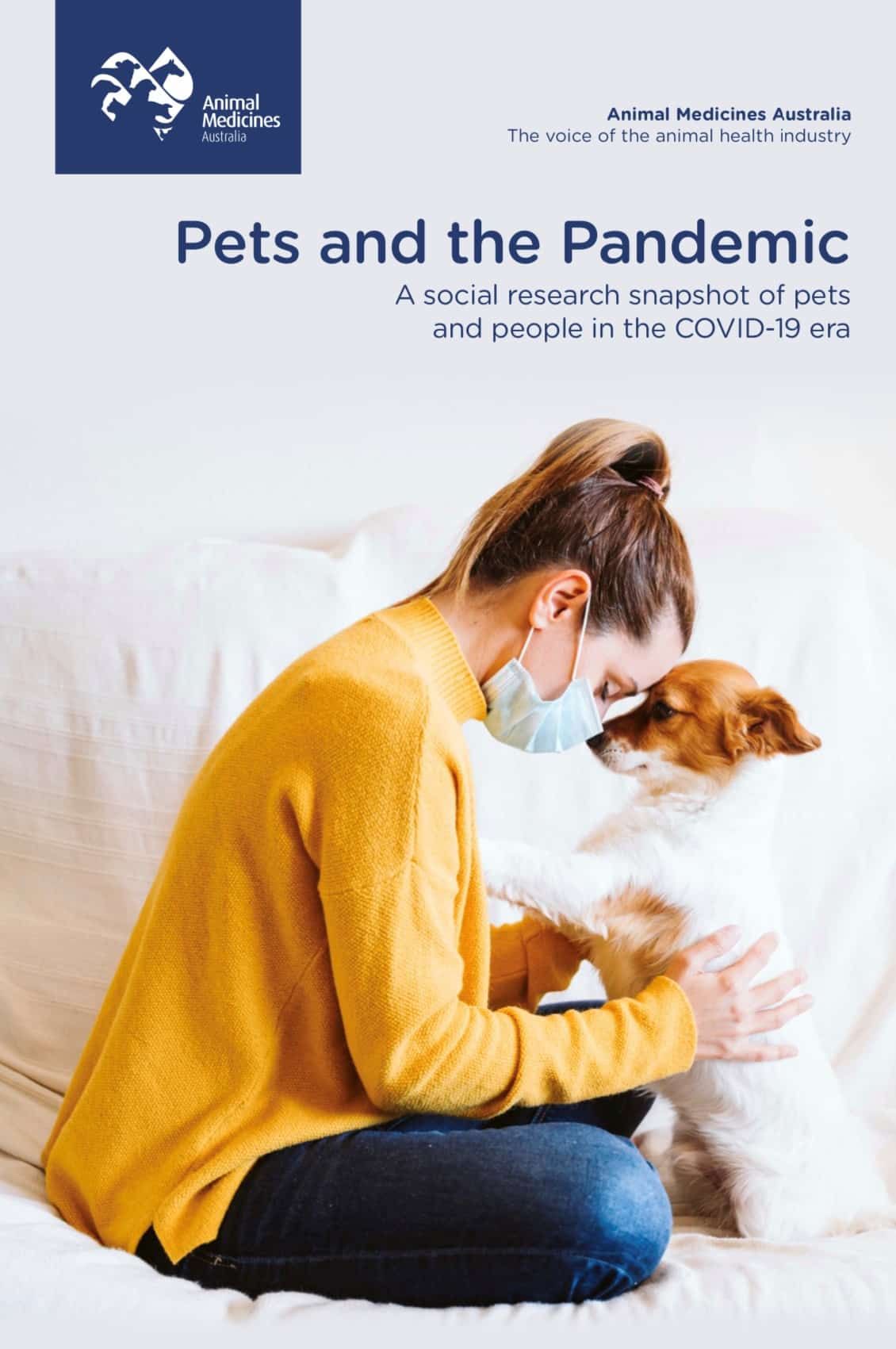 Woman in mask and yellow sweater comforts dog; cover for