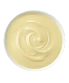 Swirled, creamy yellow sauce in a white bowl.