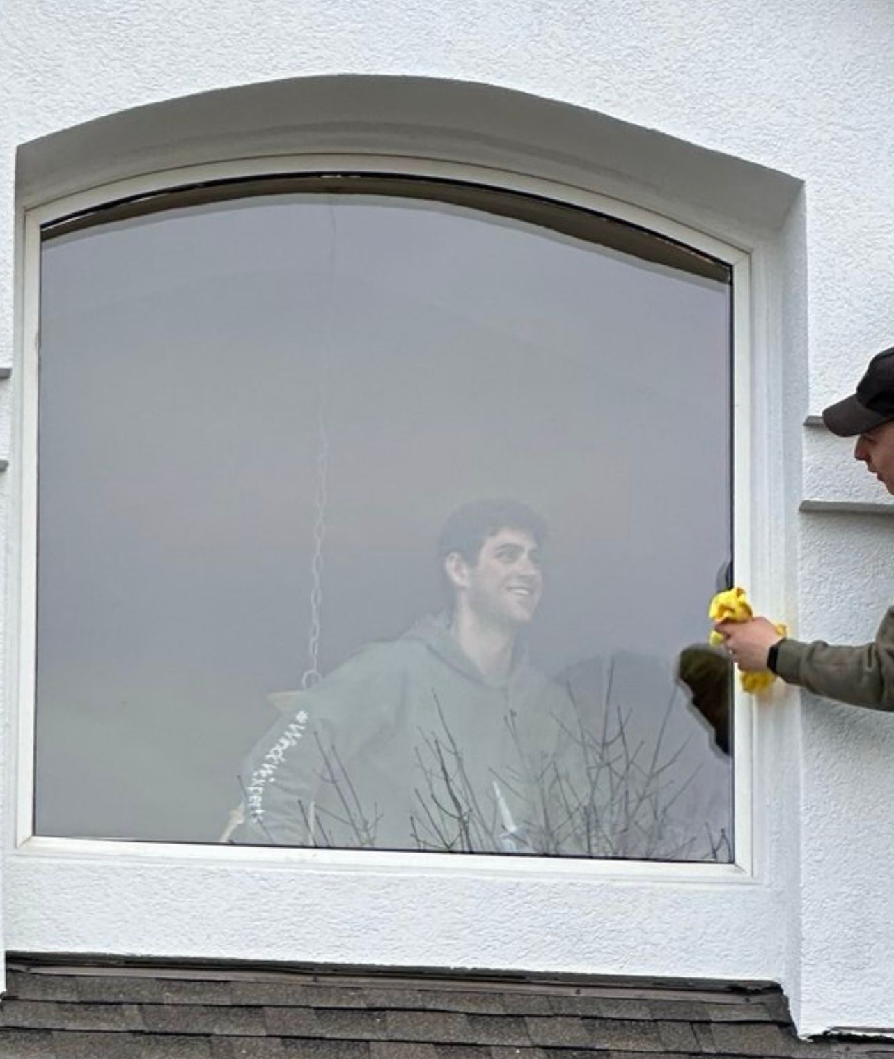 Window repair guys happy cleaning new glass they just installed 