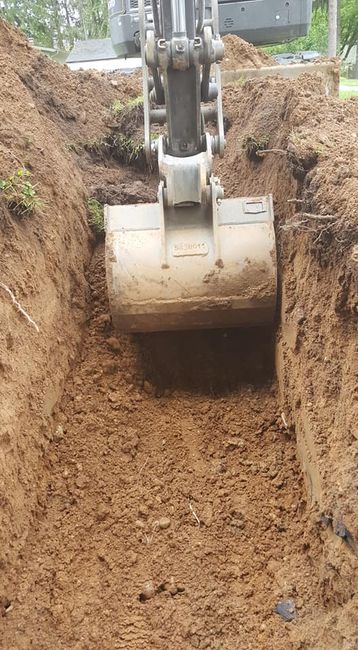 Excavator digging up hole for septic tank — White Pigeon, MI — Mercers Septic & Excavating LLC