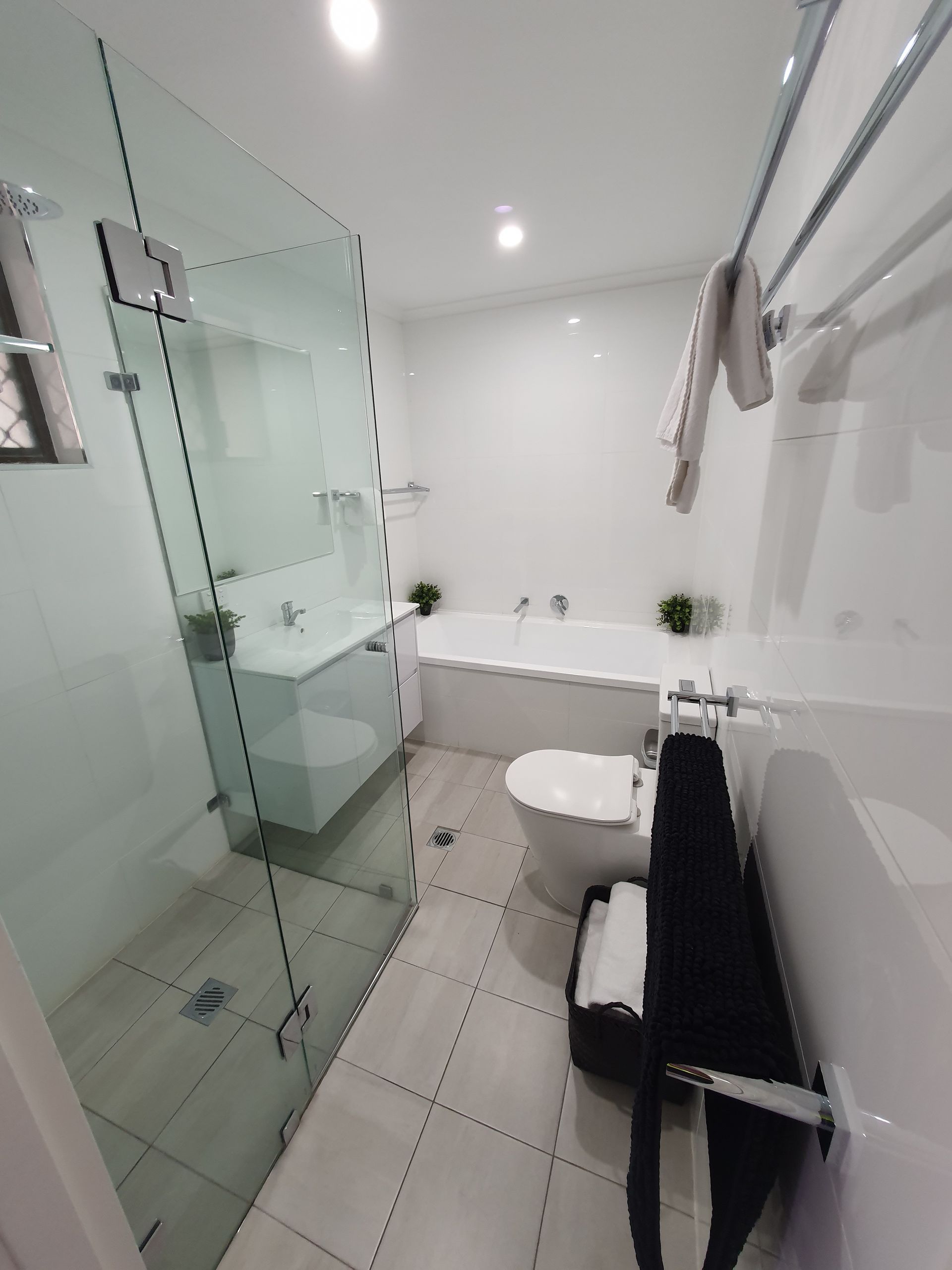 A bathroom with a toilet, sink, bathtub and shower. — Nicho's Home Maintenance In Tamworth, NSW