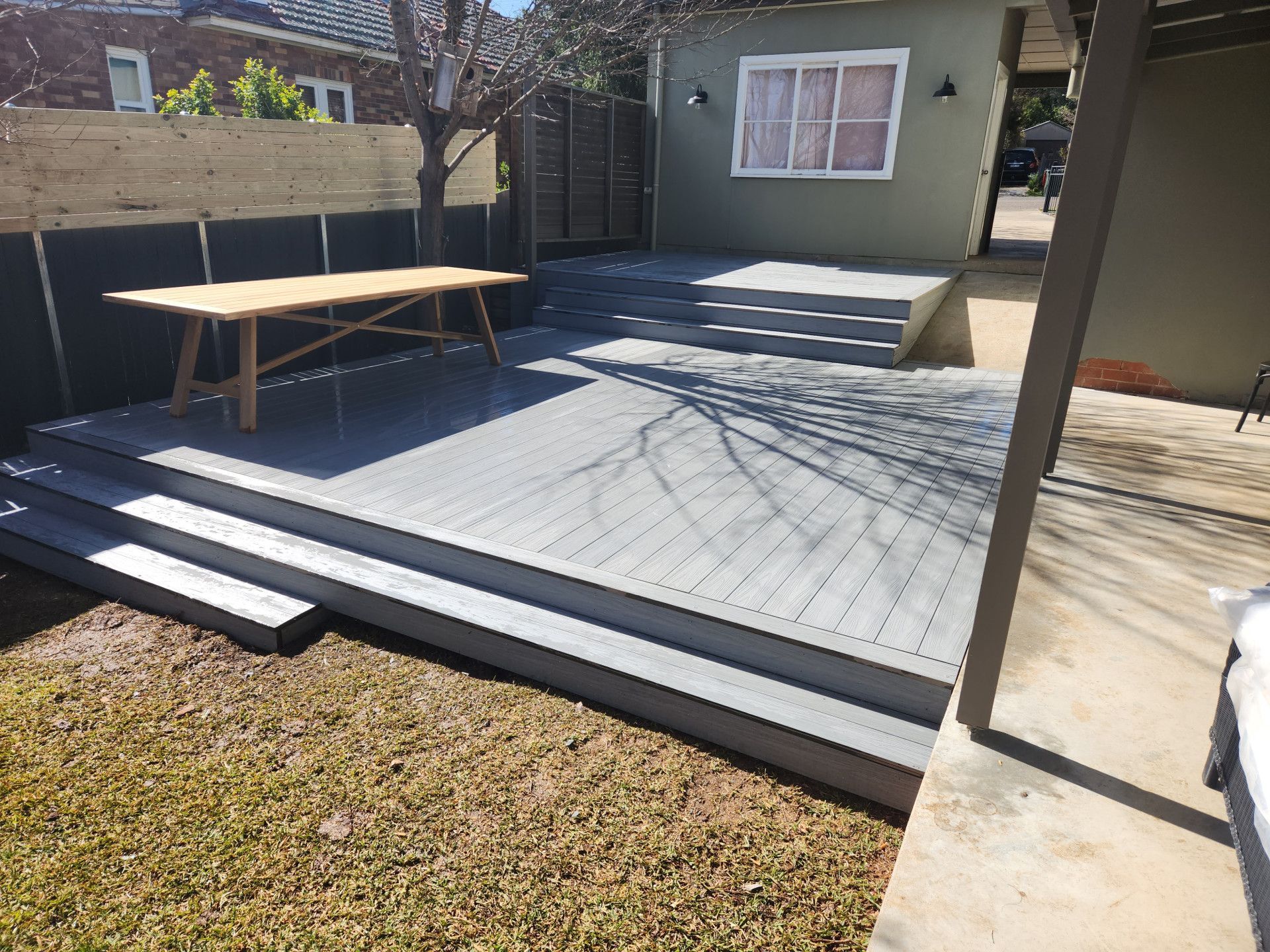 A Wooden Deck with Stairs and A Bench in The Backyard of A House — Nicho's Home Maintenance In Tamworth, NSW