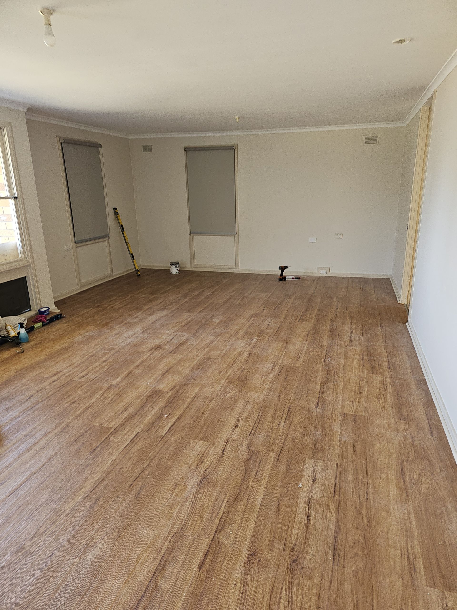 A living room with a wooden floor and white walls. — Nicho's Home Maintenance In Tamworth, NSW
