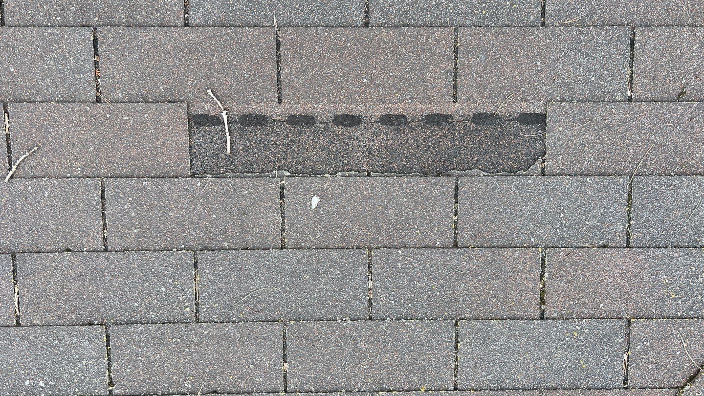 a close up of a roof with a lot of shingles on it .