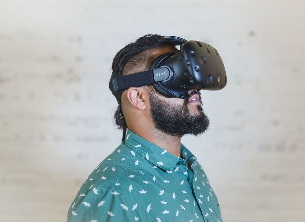 A man with a beard is wearing a virtual reality headset.