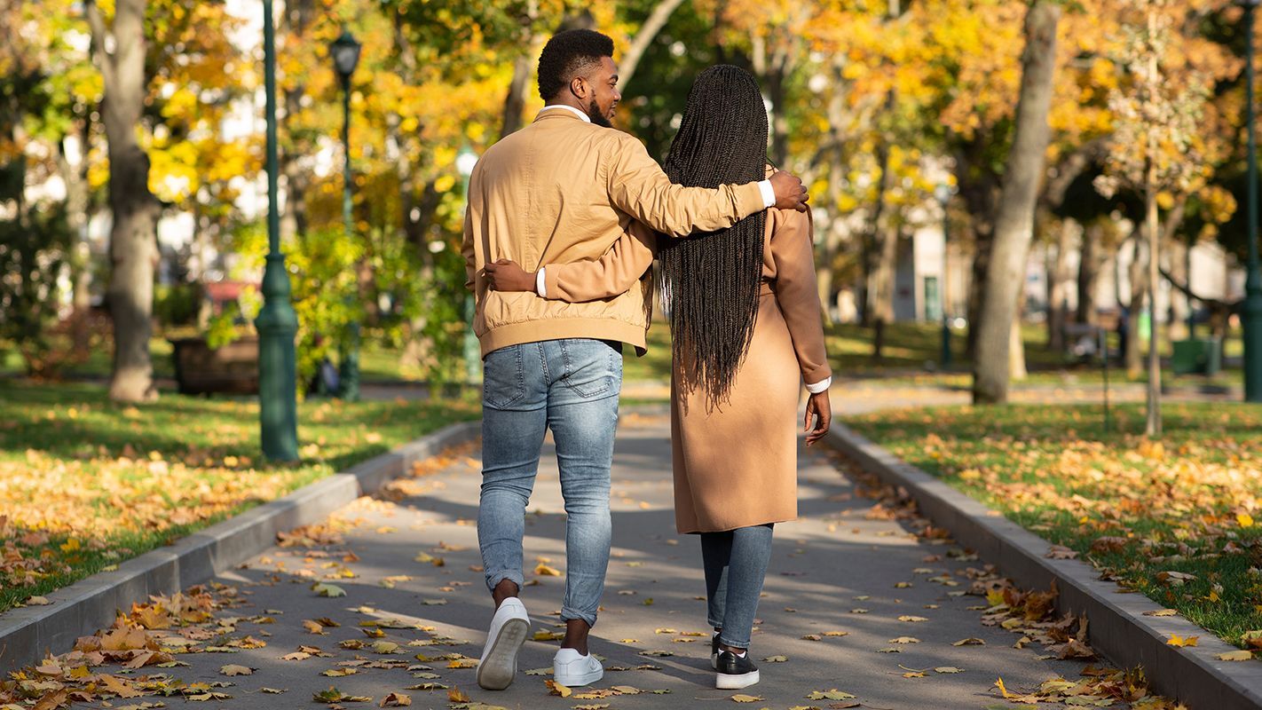 black couple walking through park