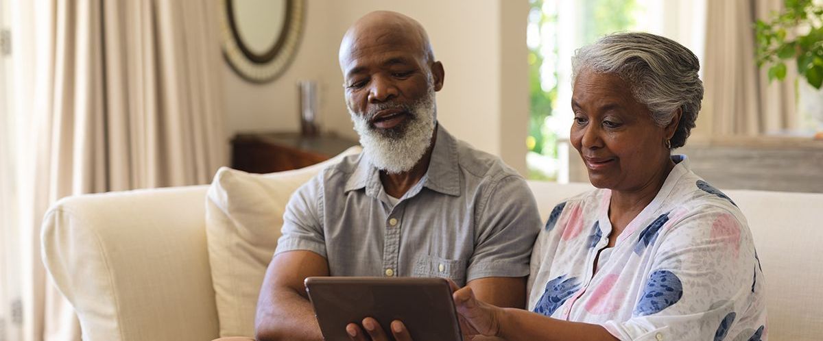 Black family looking at tablet