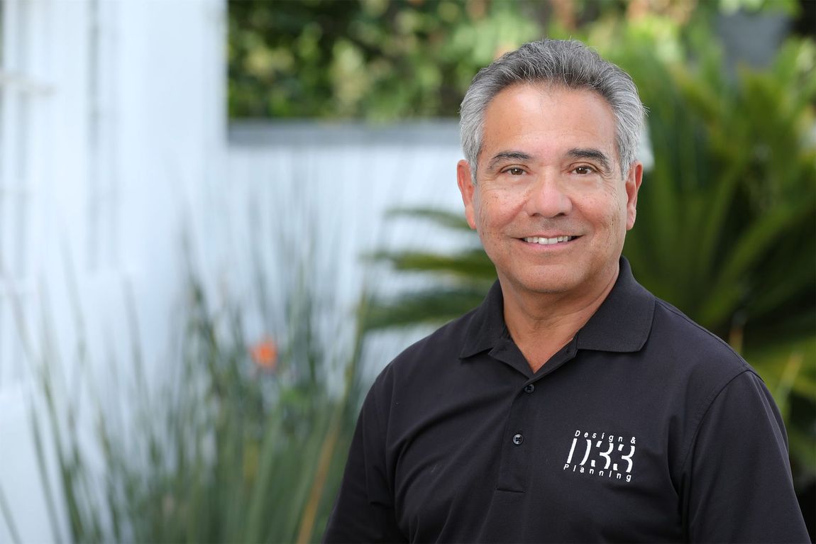 a man in a black shirt is smiling for the camera .