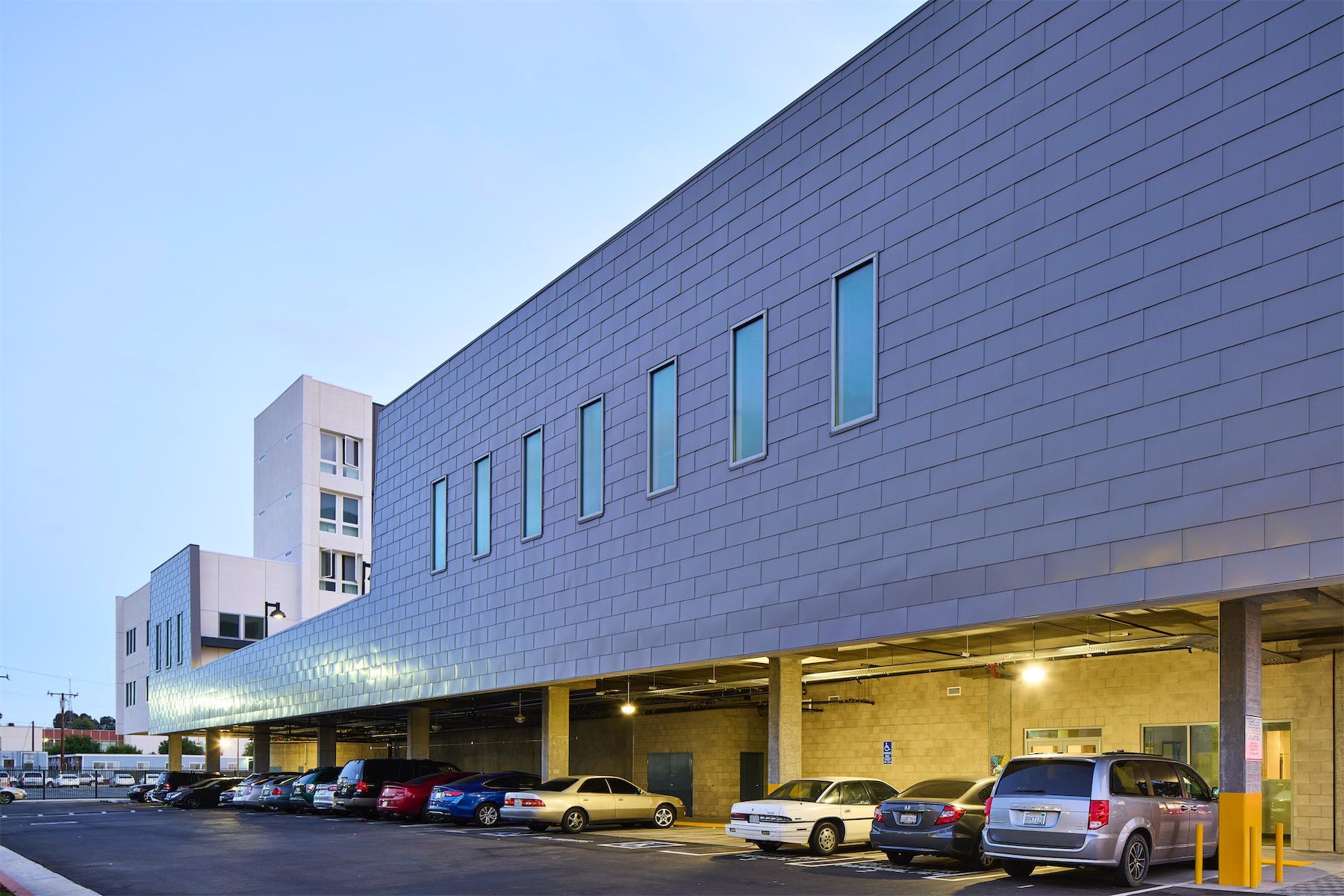 a parking lot with cars parked in front of a building