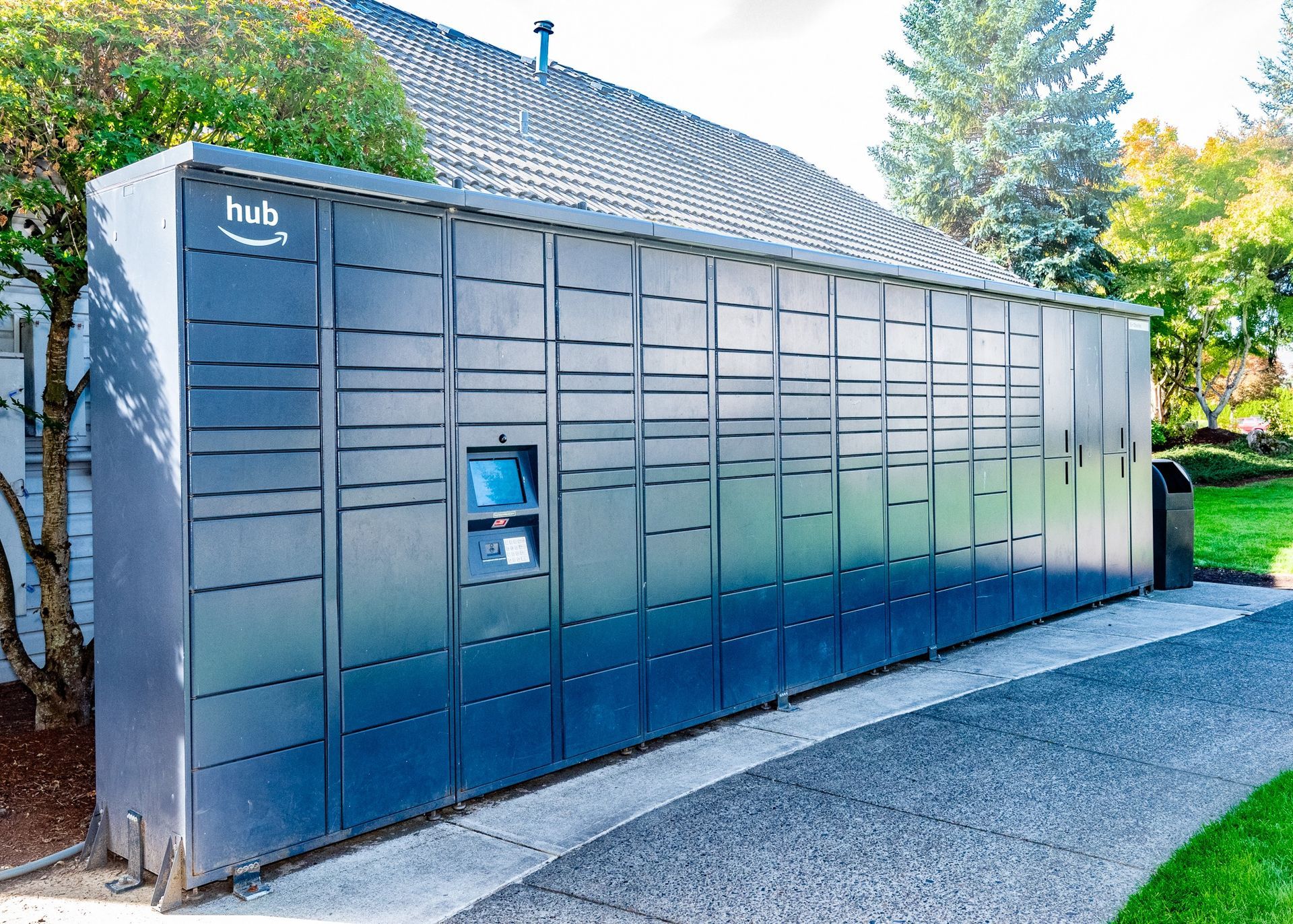 Exterior blue package locker bank with hub branding